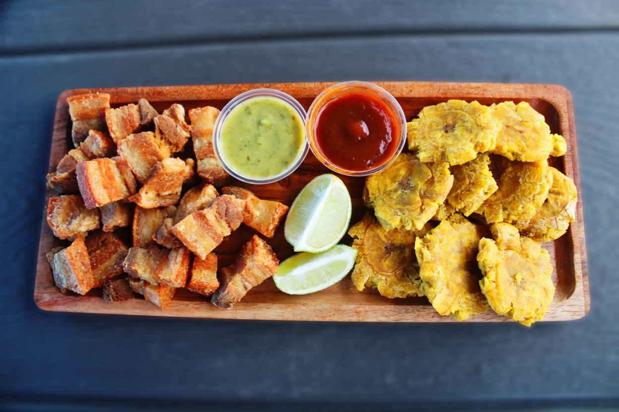 Crispy chicharrón platter with tostones — Miami BBQ